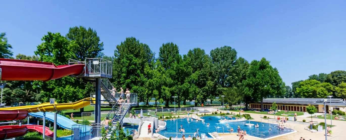 Das Foto zeigt das Rheinstrandbad Rappenwört mit Wasserrutsche und Schwimmerbecken.