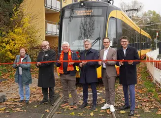 Das Foto zeigt den symbolischen Banddurchschnitt zur Eröffnung der modernisierten Bahnstrecke in Daxlanden. Dahinter steht eine Trambahn.Die abgebildeten Personen sind von links nach rechts Nach den intensiven Bauarbeiten der vergangenen Monate wurde heute die modernisierte Bahnstrecke in Daxlanden feierlich eröffnet. Über die Wiederaufnahme des Bahnbetriebs bei der Tramlinie 3 freuen sich beim symbolischen Banddurchschnitt (von links nach rechts) Karin Armbruster (1. Vorsitzende Bürgerverein Grünwinkel), Andreas Huber und Horst Kappler (Vor-stand Bürgerverein Daxlanden), Dr. Frank Mentrup (Oberbürgermeister der Stadt Karlsruhe), Christian Höglmeier (technischer Geschäftsführer der VBK) und Prof. Dr. Alexander Pischon (Geschäftsführer der VBK). 